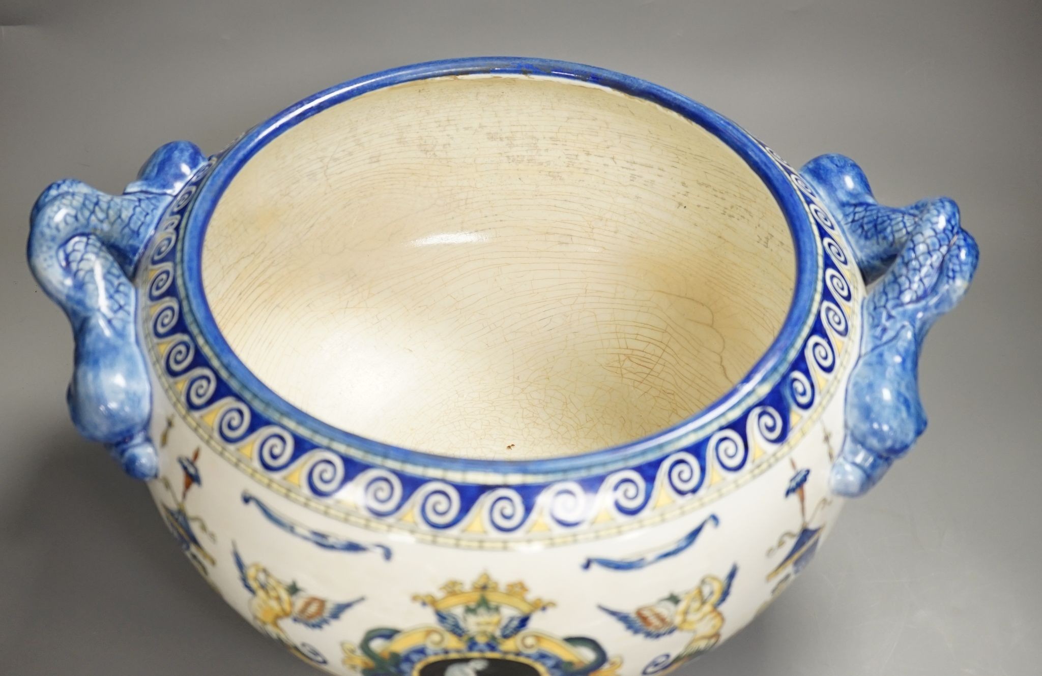 A French 19th century Gien pottery jardiniere with dolphin handles, 41 cms wide including handles.